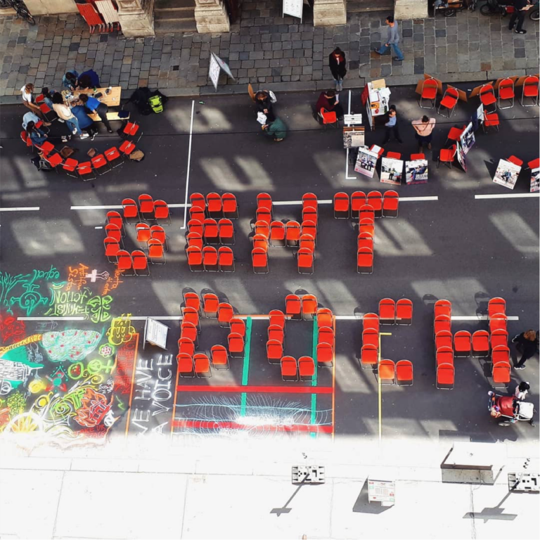 Ein Luftbild von einer Demonstration zeigt Sessel, die den Schriftzug "Geht Doch" bilden